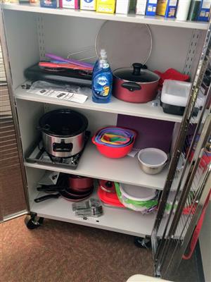 The cabinet which stores a lot of the equipment needed for cooking in the classroom. 