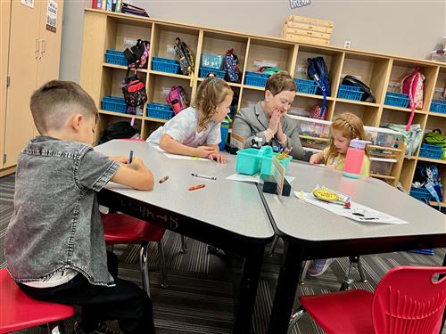 Dr. Swift celebrates a Sunset Hill kindergartners' success with using scissors for the first time.